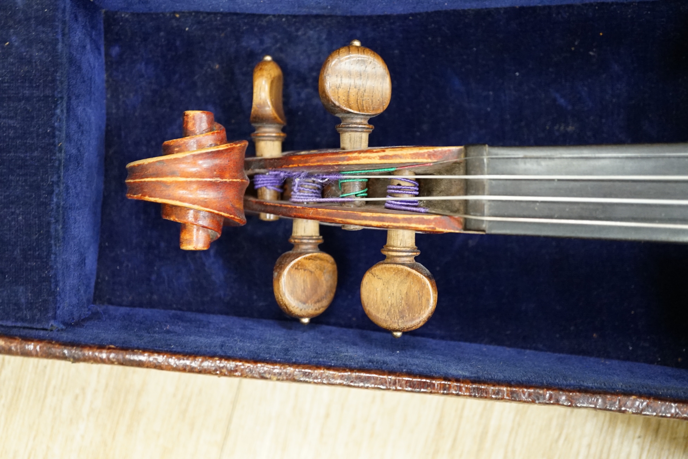 An English cased violin by Thomas J. Bellingham, Leeds, 1909, body length, 35.5cm, with a chased silver mounted bow CITES Submission reference WNR7TU27